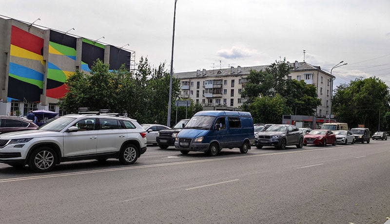 автомобили стоят на светофоре в городе